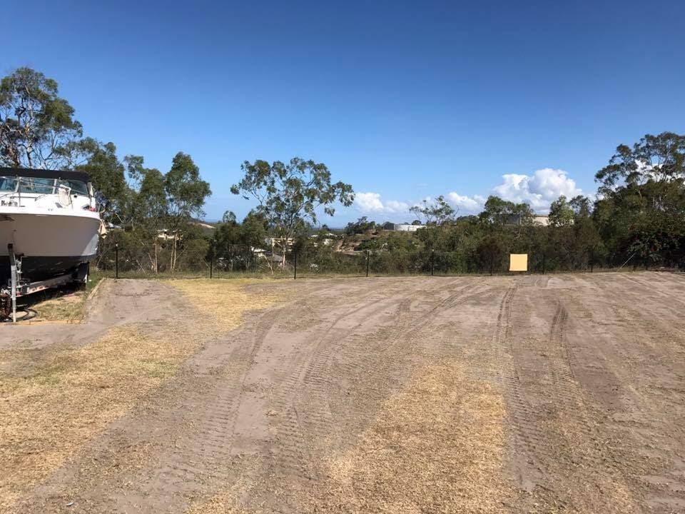 A Boat is Parked in the Middle of a dirt field — Curtis Coast Excavators in Gladstone, QLD