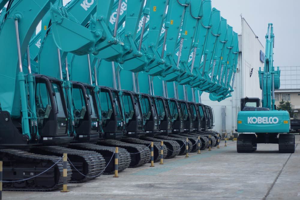 A Row of Kobelco Excavators are Parked in a Parking lot — Curtis Coast Excavators in Gladstone, QLD