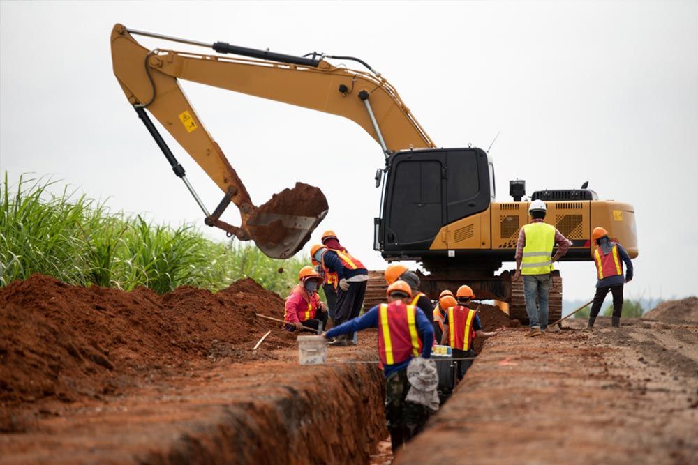 A Group of Construction Workers are Working on a Construction site — Curtis Coast Excavators in Gladstone, QLD