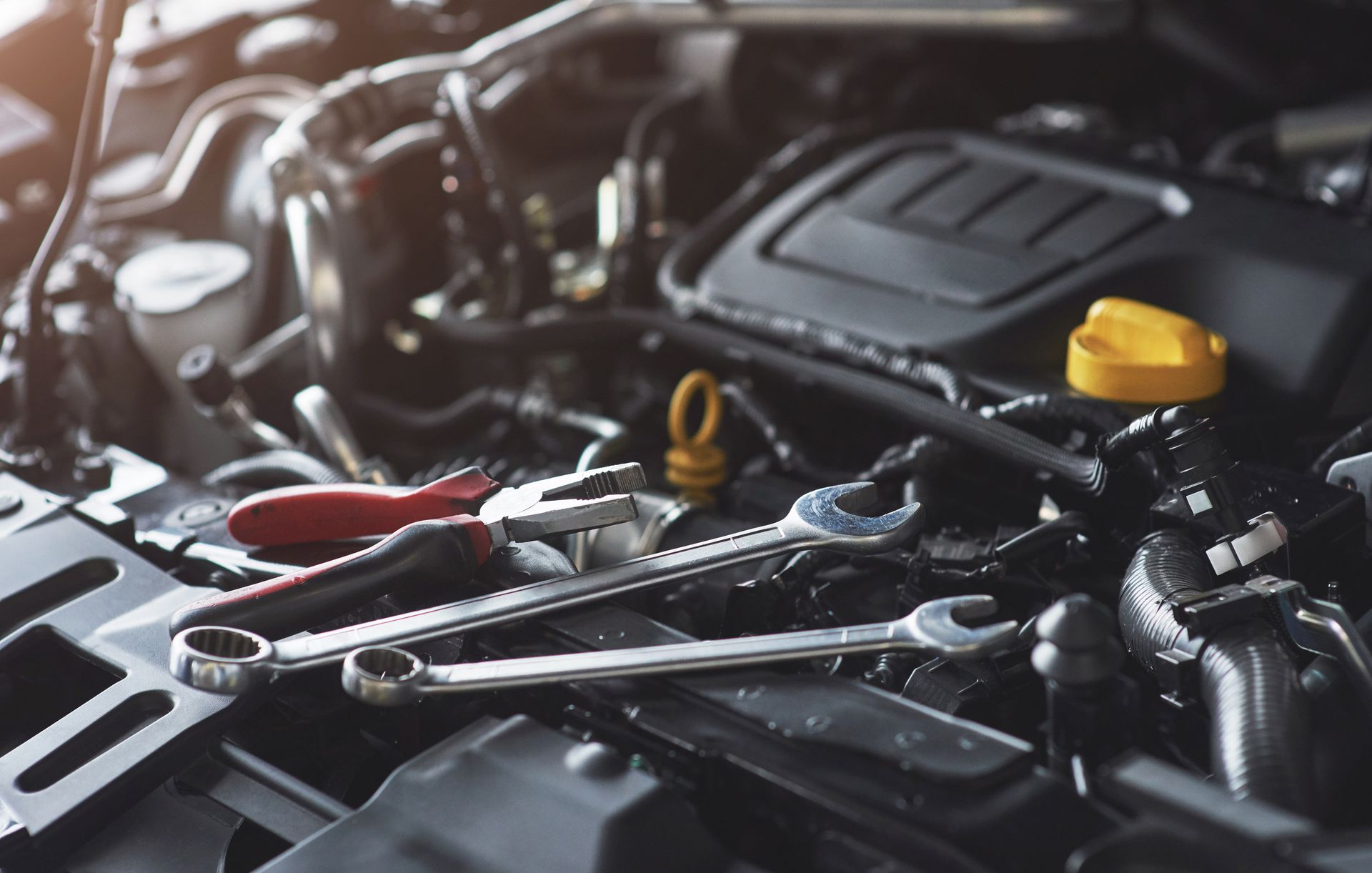 A close-up of a car engine with tools on it