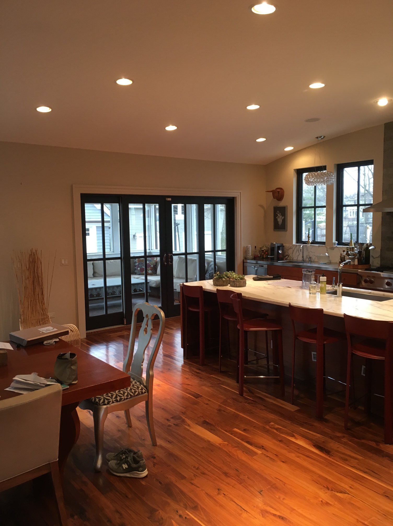 Kitchen with hardwood floors, dark wood island, and French doors to exterior.