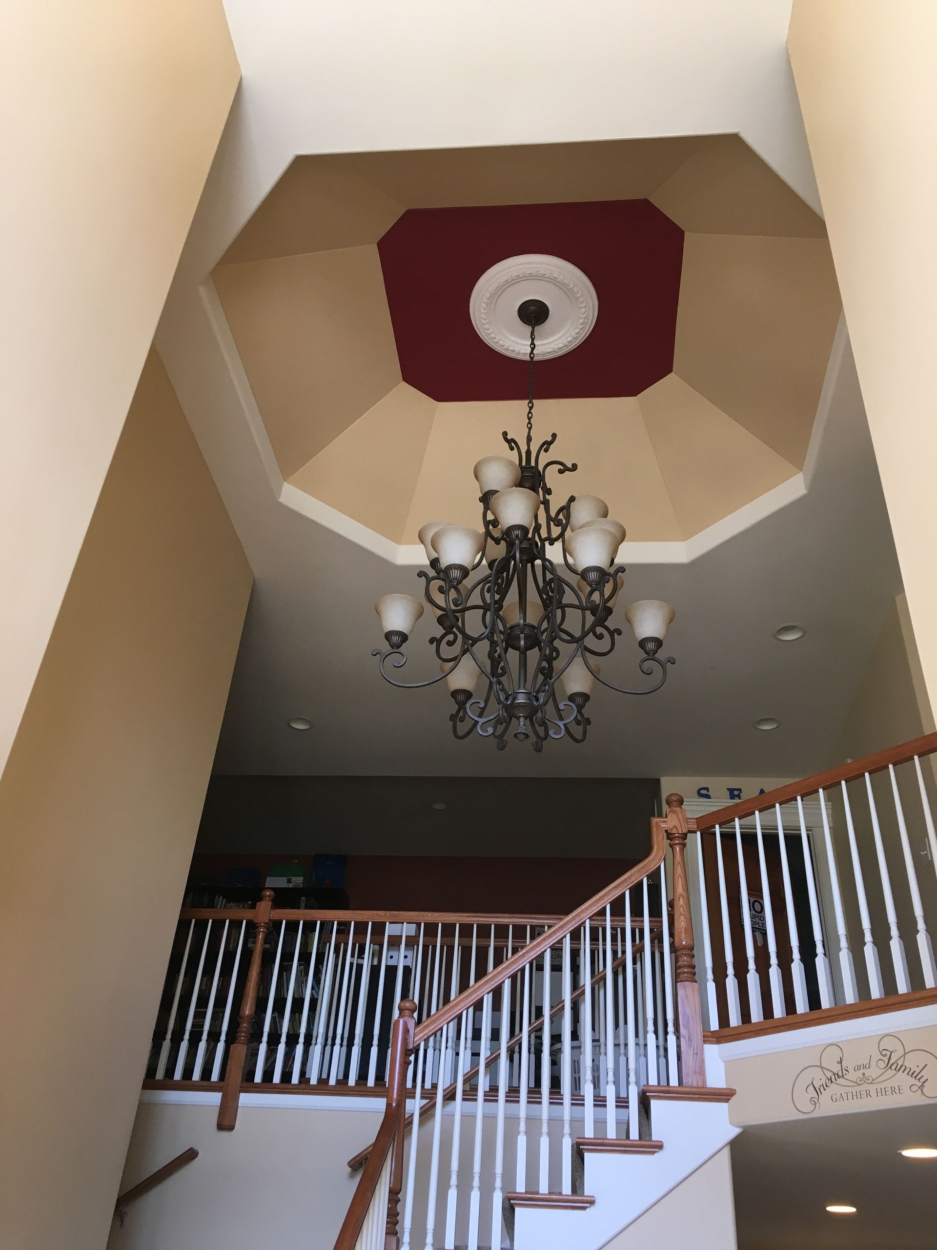 House exterior partially painted white, revealing exposed wood. Ladders, fall foliage present.