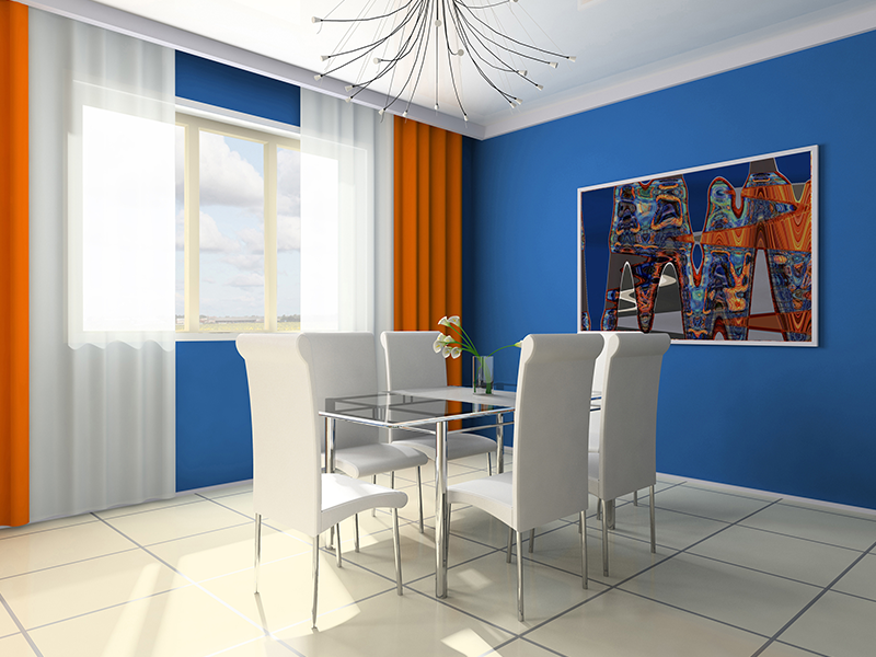 Dining room with blue walls, white chairs, glass table, orange and white curtains, and artwork.