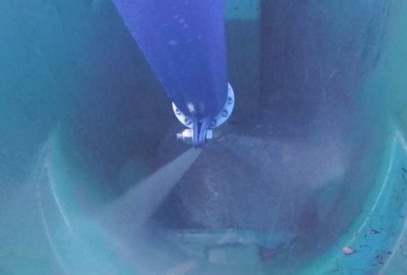 A close up of a blue object being sprayed with water.