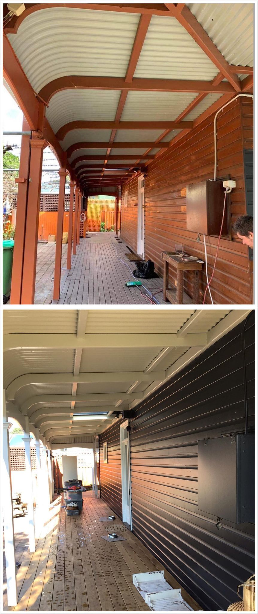 A long, covered walkway with brick walls and a corrugated roof.
