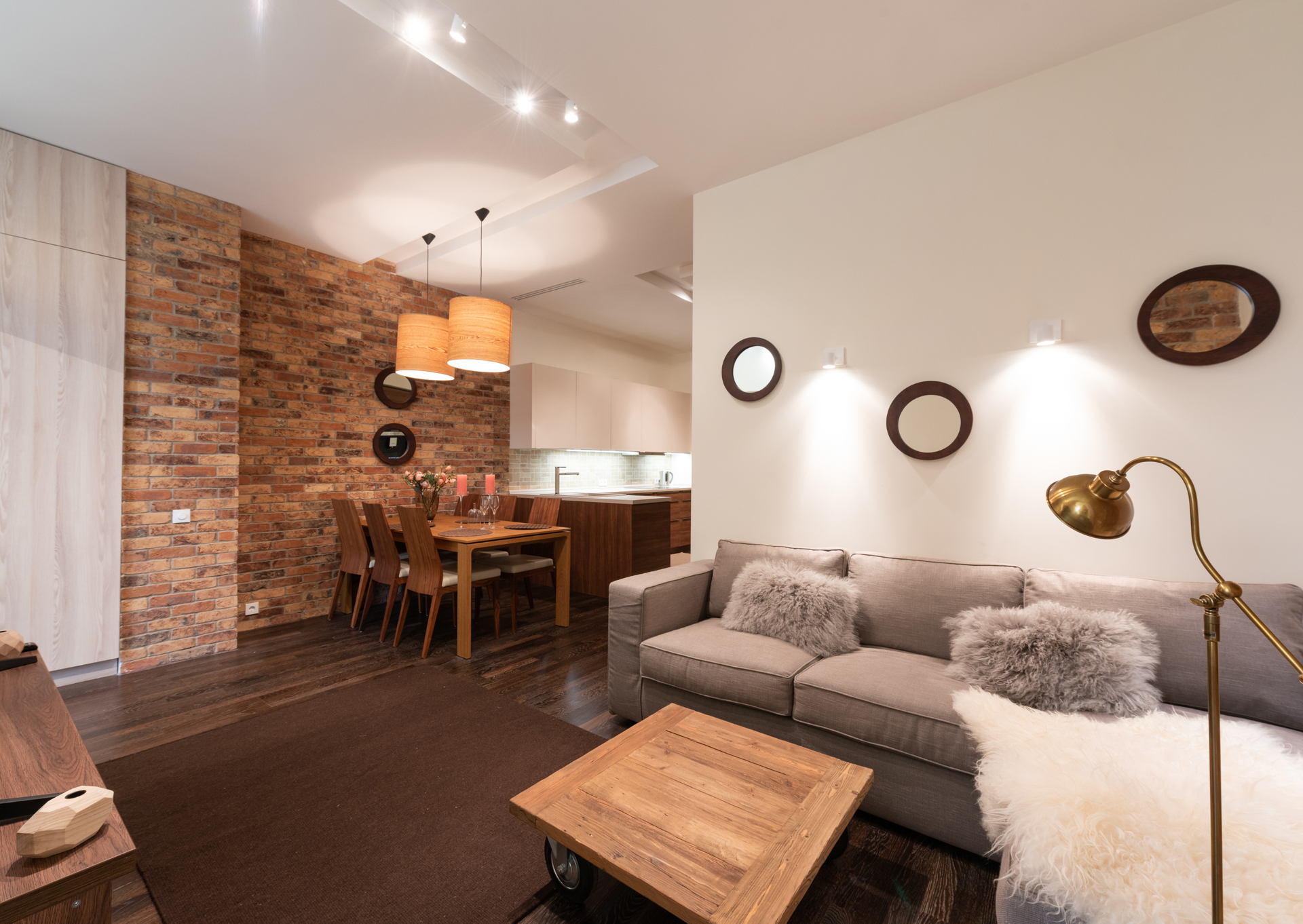 A living room with a couch , table , and lamp.
