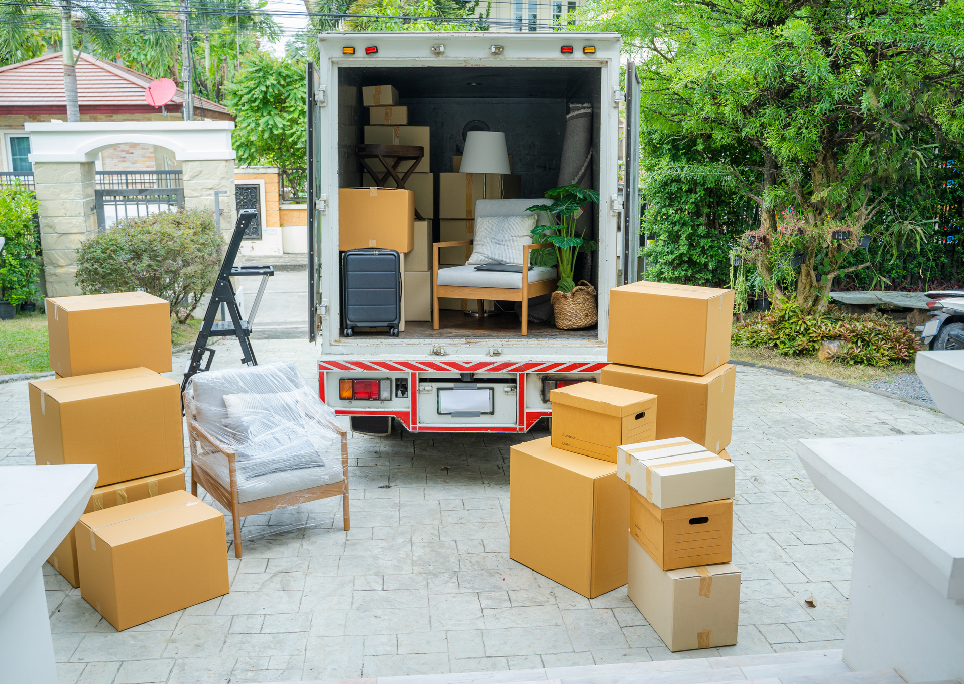 A moving truck is filled with boxes and furniture.