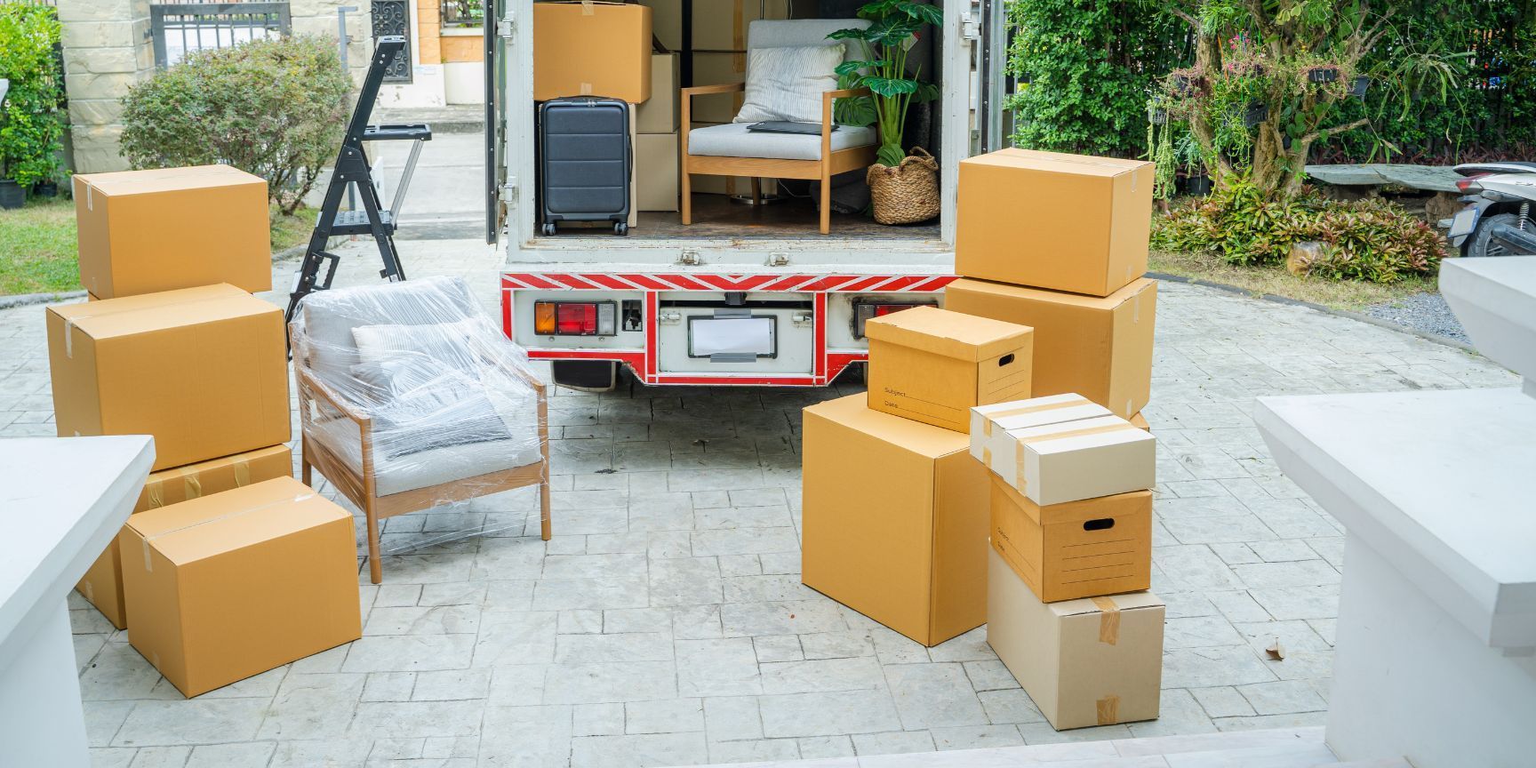 A moving truck is filled with boxes and furniture.