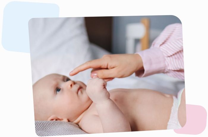 newborn egg donor baby looking at finger of her mother