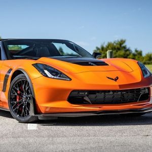 A close up of an orange corvette zr1 with FormulaOne window tint.