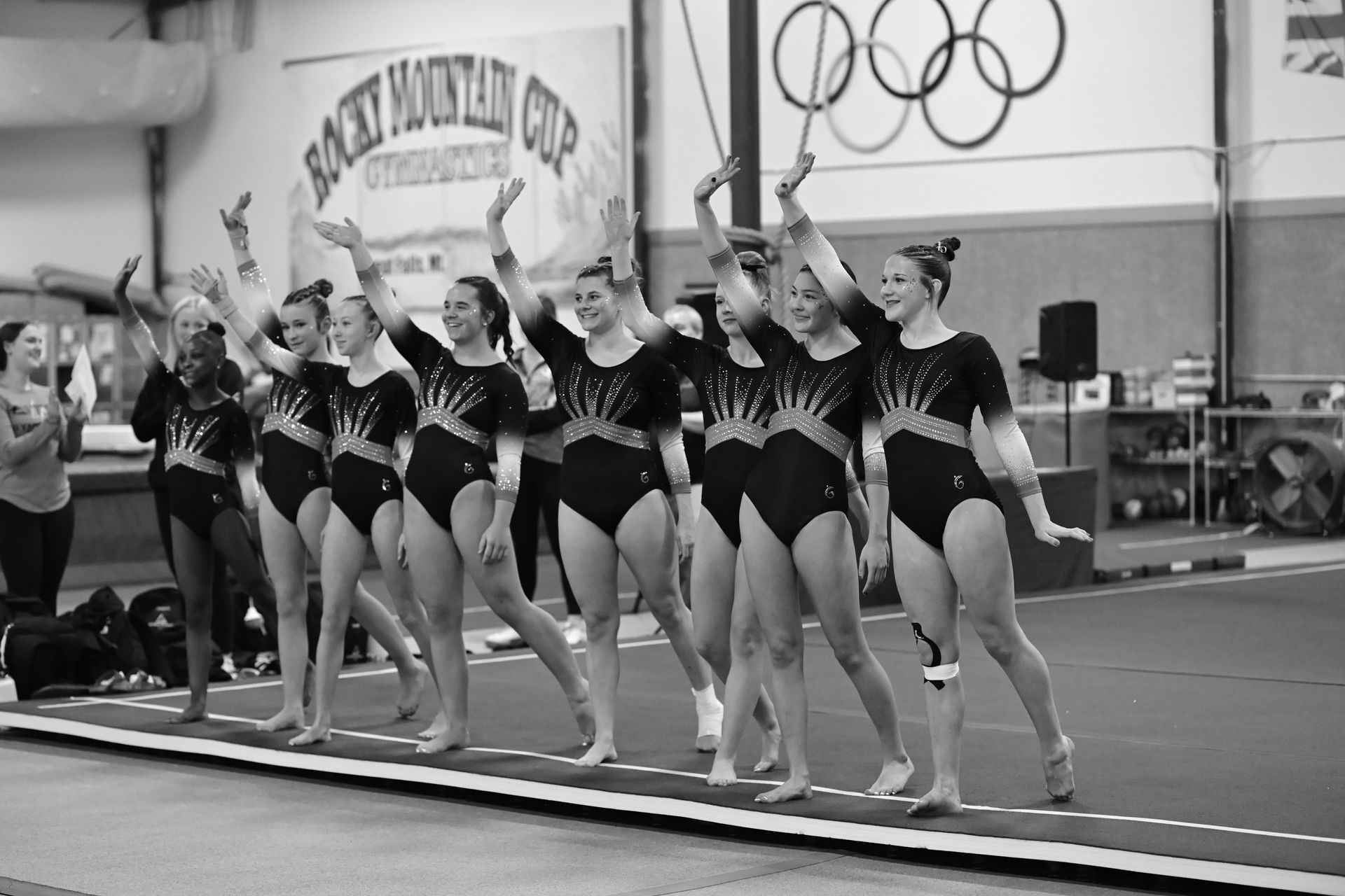 A group of girls are standing on a podium holding a sign that says 2024 1st place team