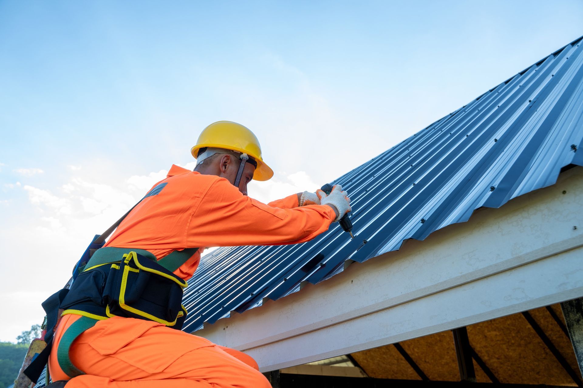 A roofer installing a new metal roof for a residential property in Bluffton, SC. A roofer installing a new metal roof for a residential property in Bluffton, SC.