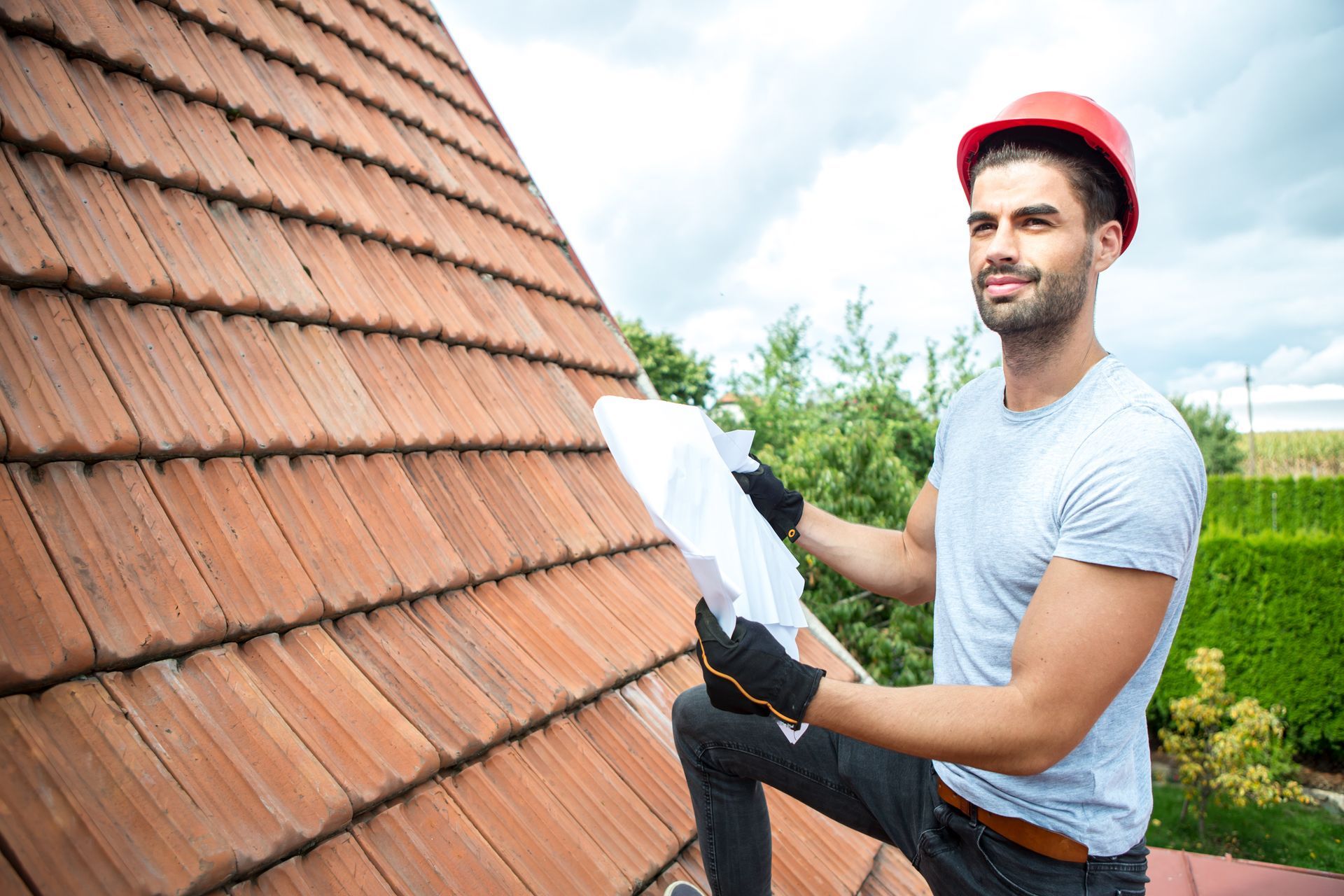 A man is inspecting a roof.