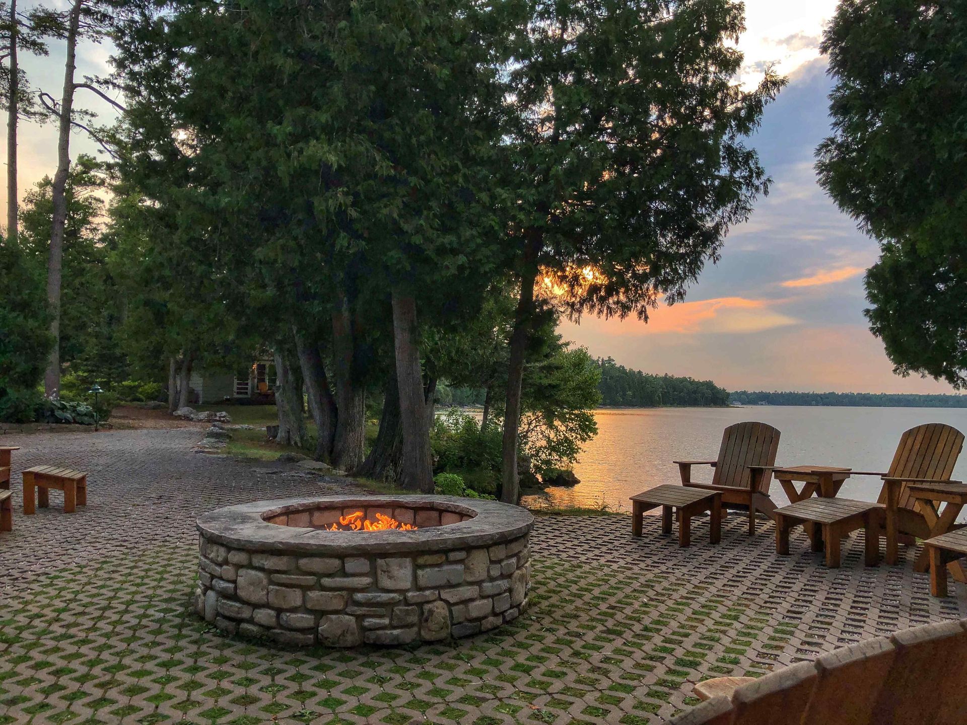 Rounded Fire Pit at Dusk with Lake view