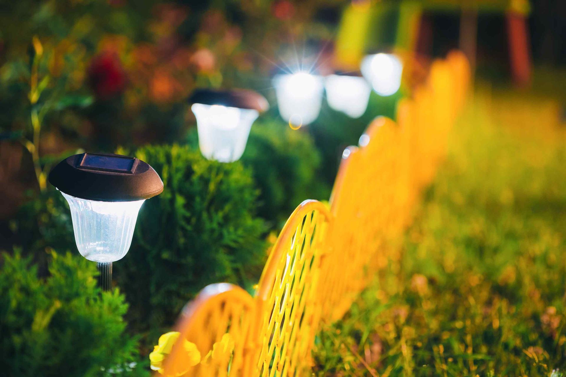 small solar garden-light lantern in flowerbed