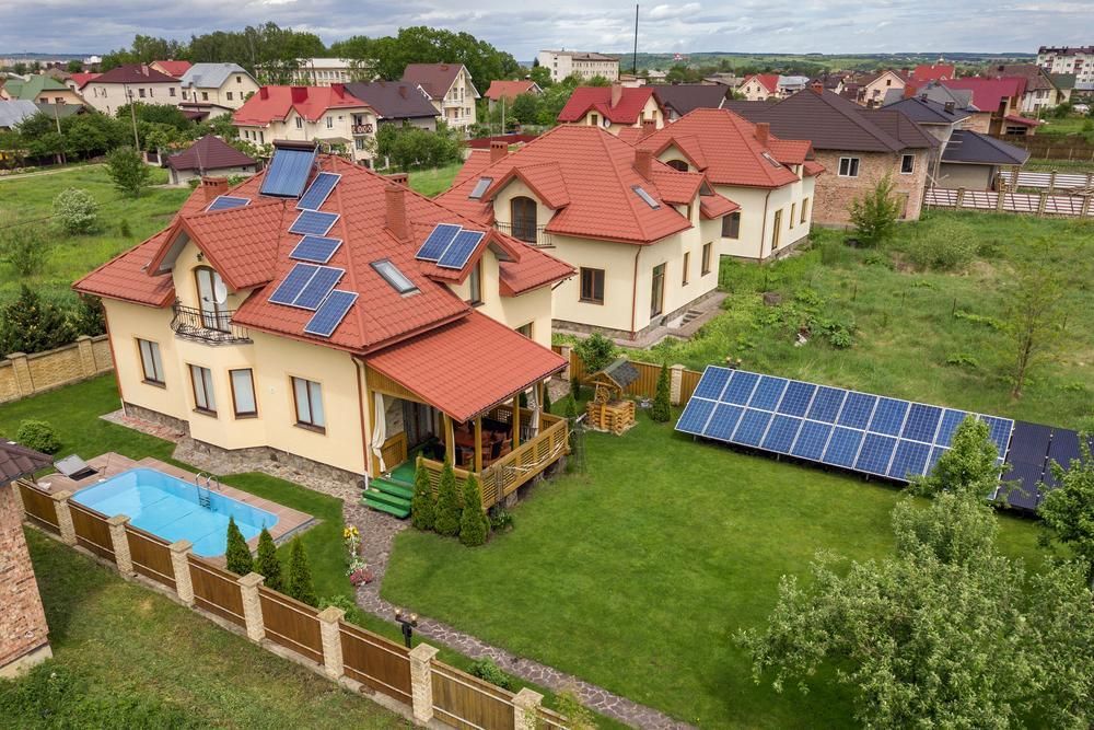 An Aerial View Of A House With A Pool And Solar Panels On The Roof — Mission Solar And Electrical In Innisfail, QLD