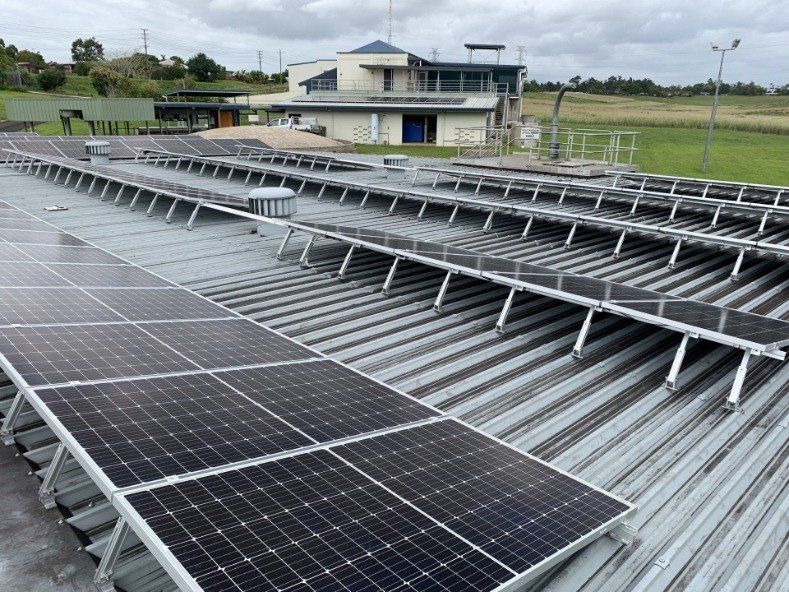Solar Panels Installed On A Roof Of Warehouse — Mission Solar And Electrical In Mission Beach, QLD