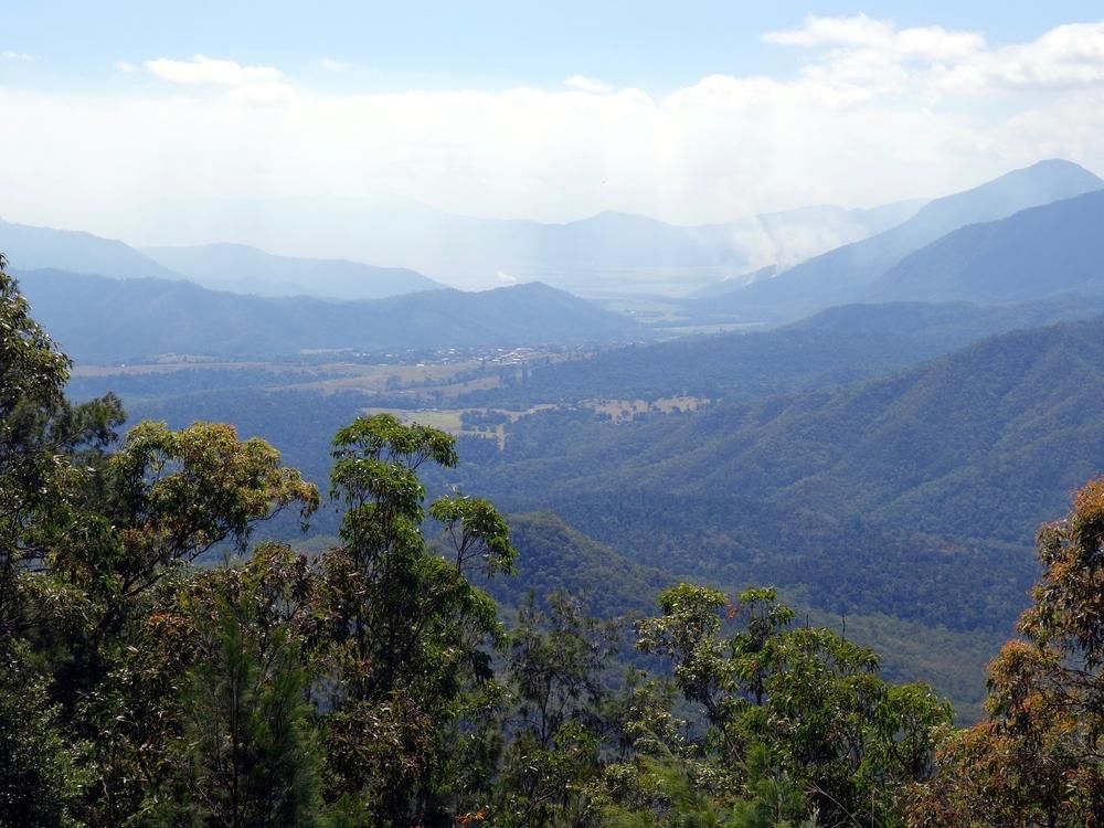 A View Of A Mountain Range With Trees In The Foreground  — Mission Solar And Electrical In Innisfail, QLD