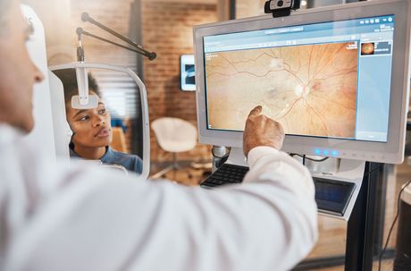 Tomography, medical and ophthalmology with eye exam and doctor for vision, healthcare and screening test. Lens, review and optometry with patient and man for retina picture, results and medicine