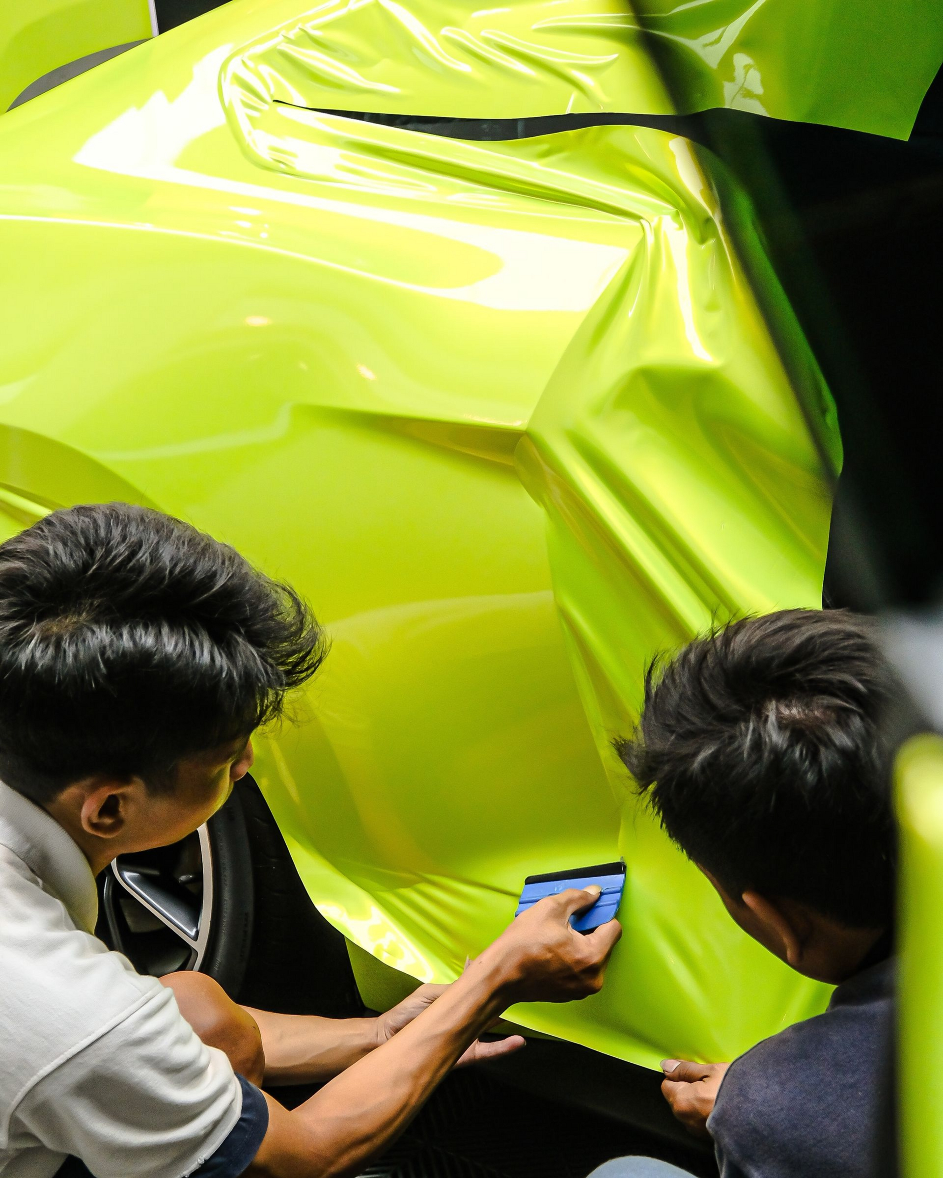 A person is cleaning the interior of a car with a vacuum cleaner.