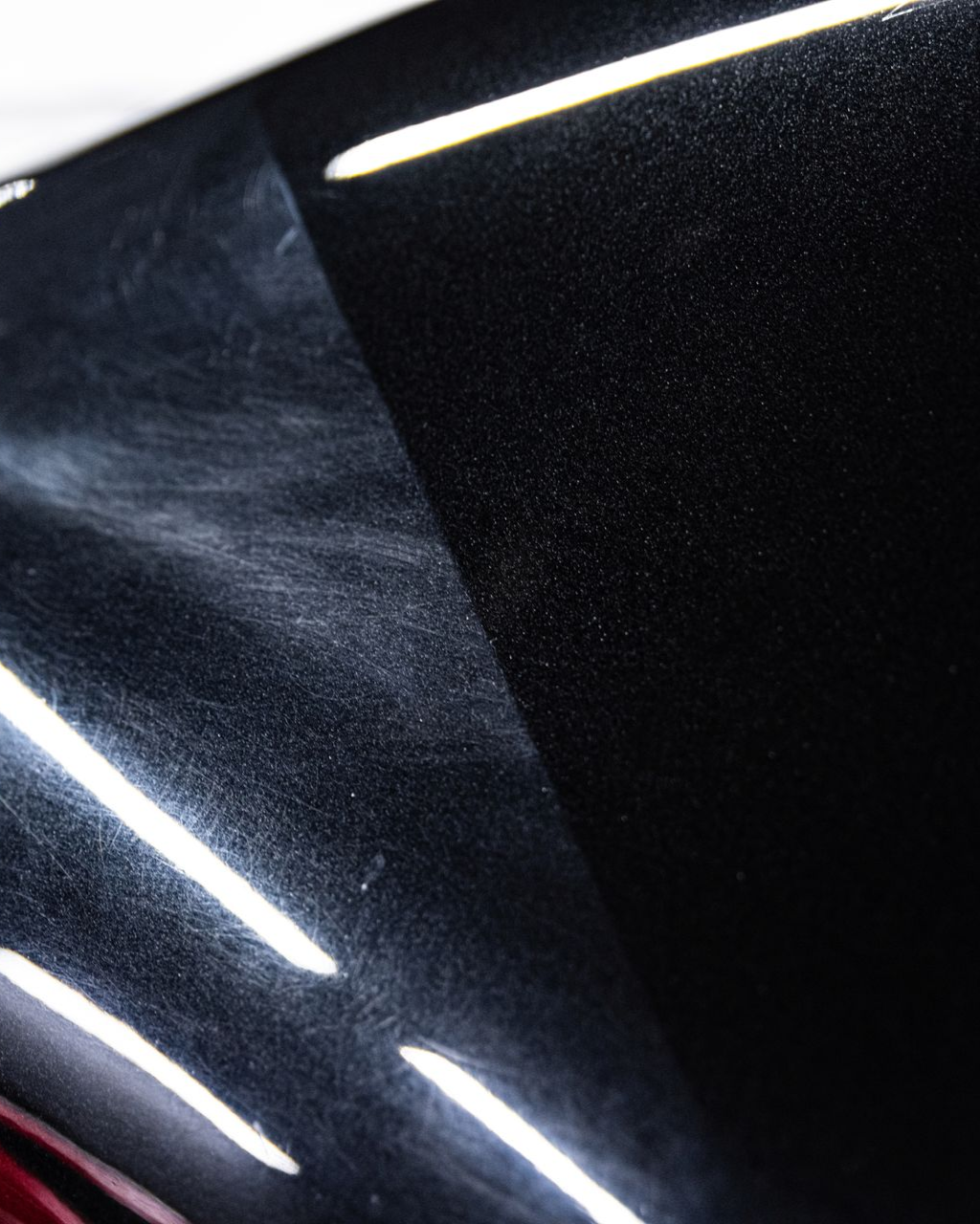 A yellow sports car is parked in a garage.