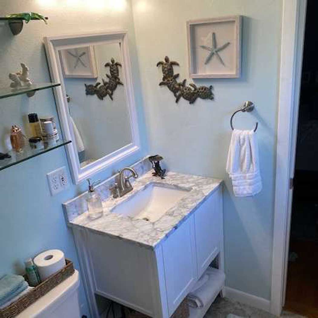 A bathroom with a sink , mirror and toilet.