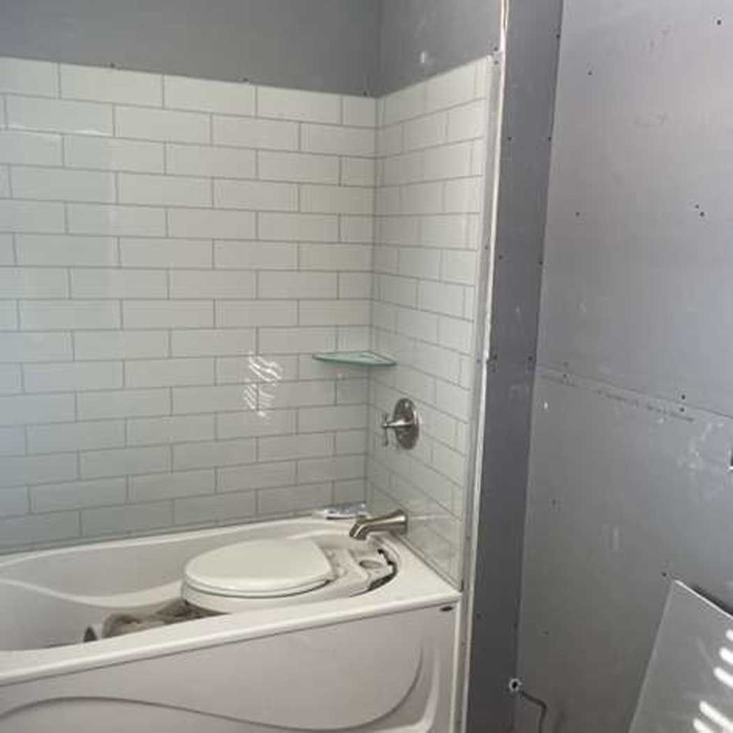 A bathroom with a bathtub and a toilet.