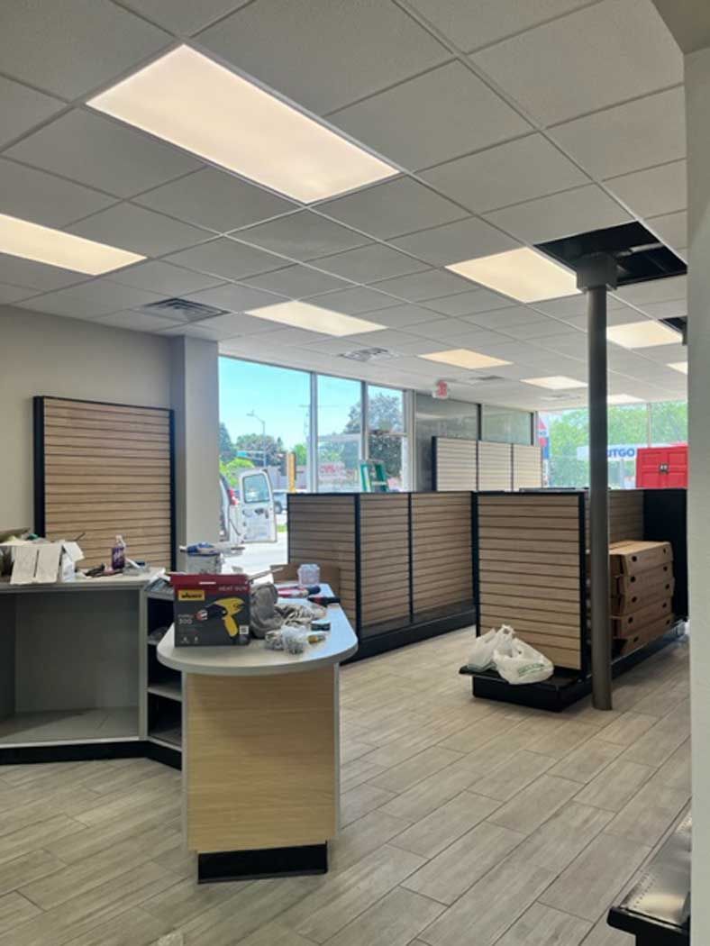 A large room with a lot of windows and a table in the middle of it.