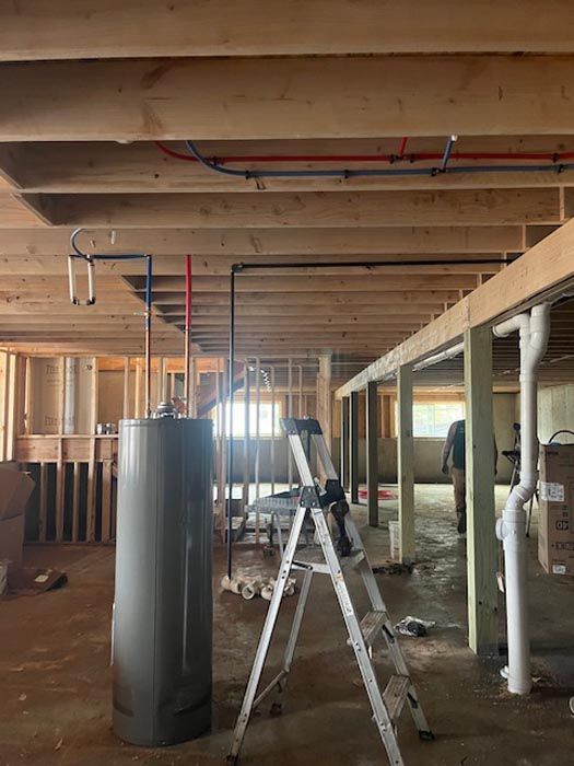 A ladder is sitting in the middle of a room under construction.