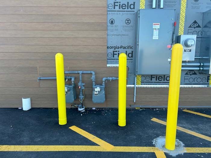 Yellow poles in front of a building that says efield