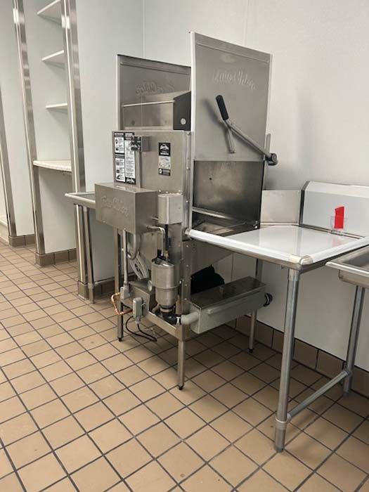 A kitchen with stainless steel appliances and a tiled floor.