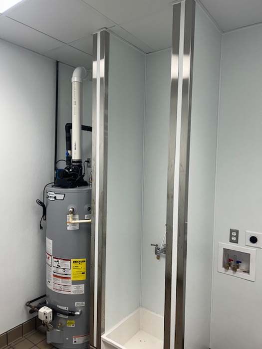 A bathroom with a water heater and a sink.