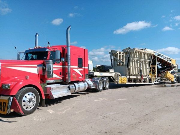 A red semi truck with a trailer attached to it