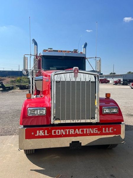 A red truck with j & l contracting llc written on the bumper
