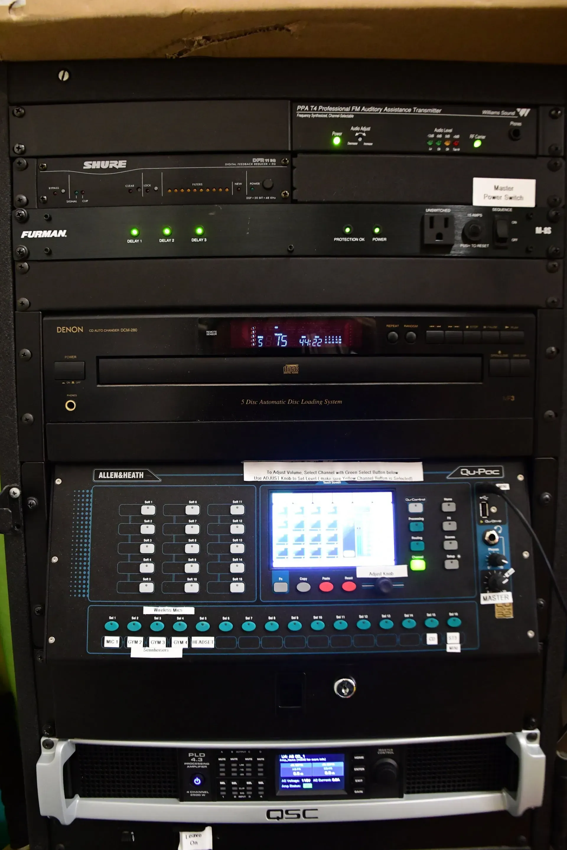 A rack with a cd player on top of it