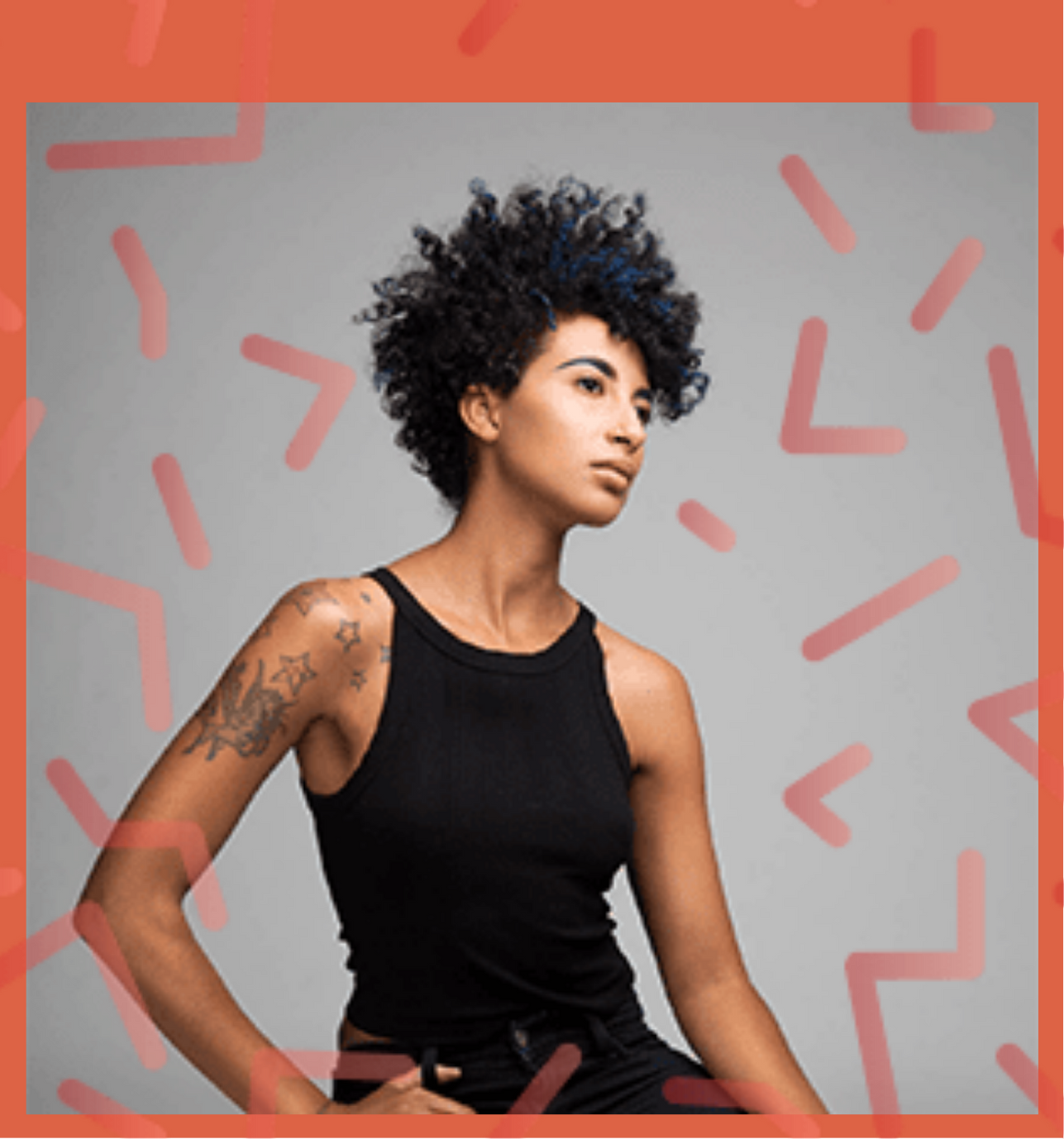 A woman in a black tank top has a tattoo on her arm