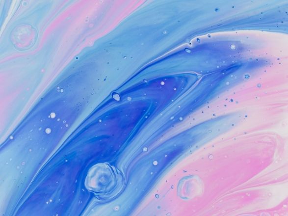 A close up of a blue and pink paint swirl.