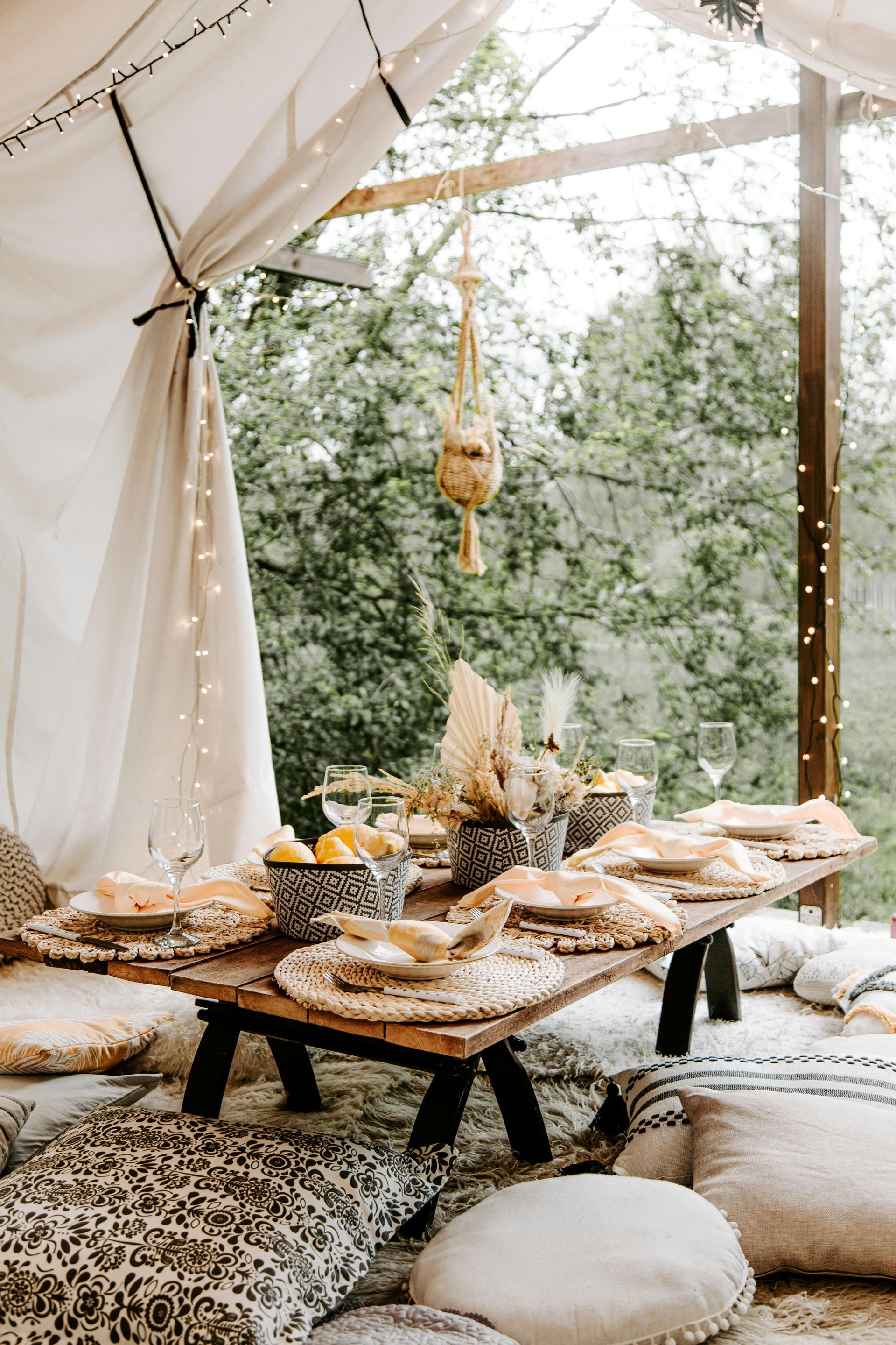 A table with a lot of food on it is sitting under a tent.