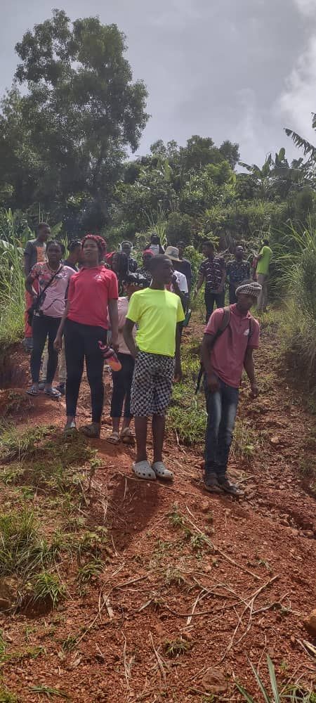 Teens walking down a dirt path.