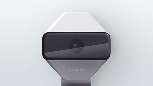 A xfinity device is sitting on a white surface