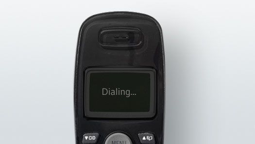 A black cell phone with a screen that says dialing on it.