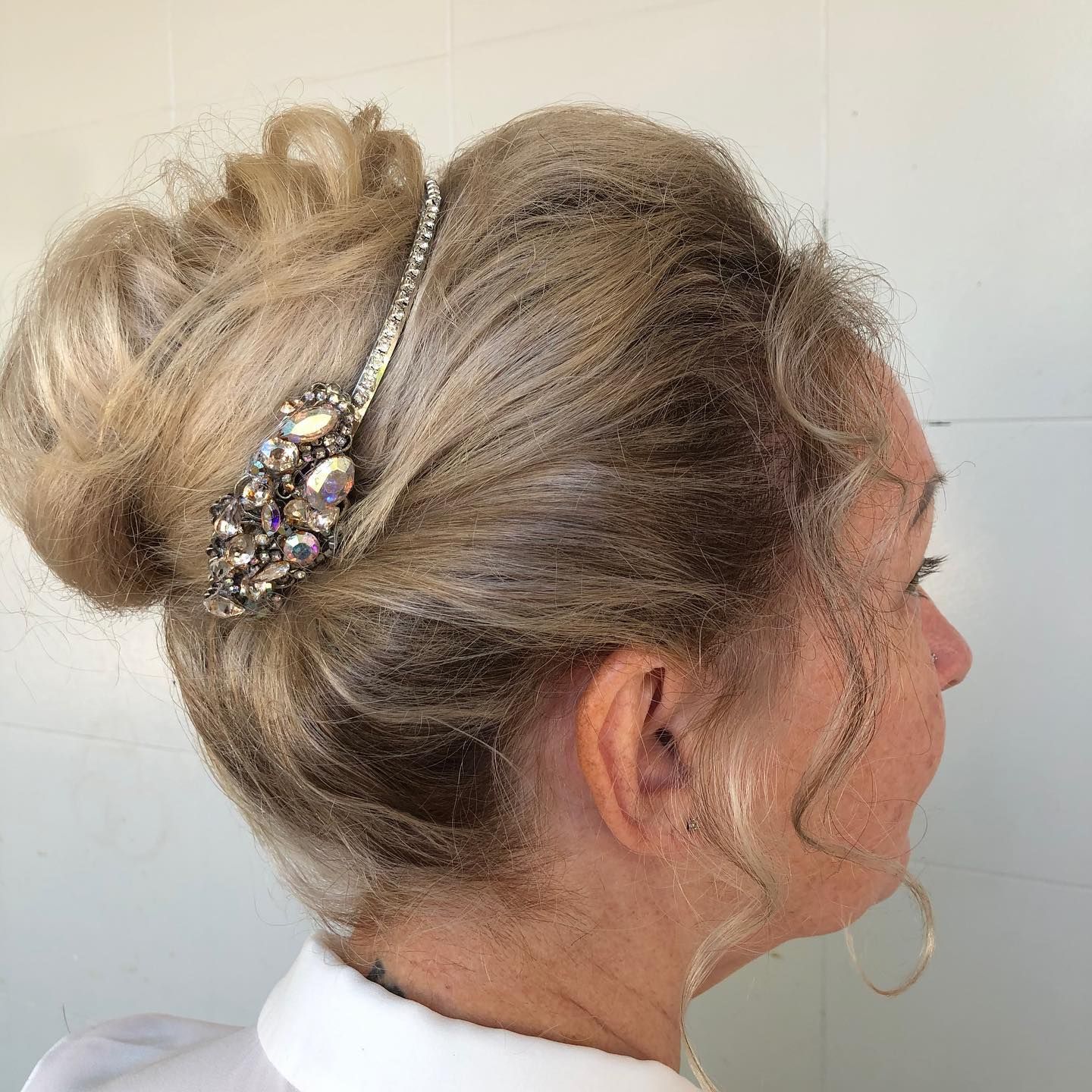 A woman with her hair in a bun and a jewelled head piece — Carlee Hair Design In Anula, NT