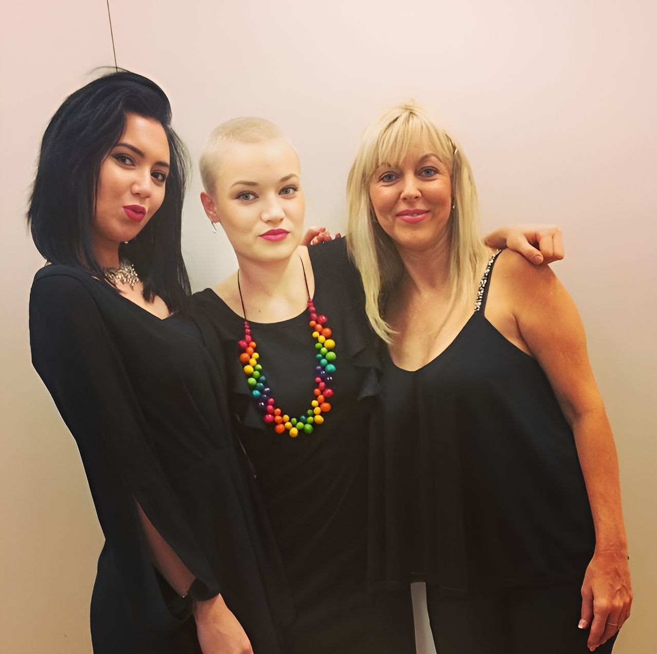 Three Women Posing For A Picture With One Wearing A Rainbow Necklace — Carlee Hair Design In Anula, NT