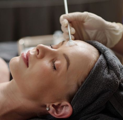 A woman is getting a botox injection in her head.