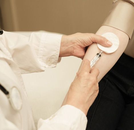 A woman is getting a facial treatment at a beauty salon.