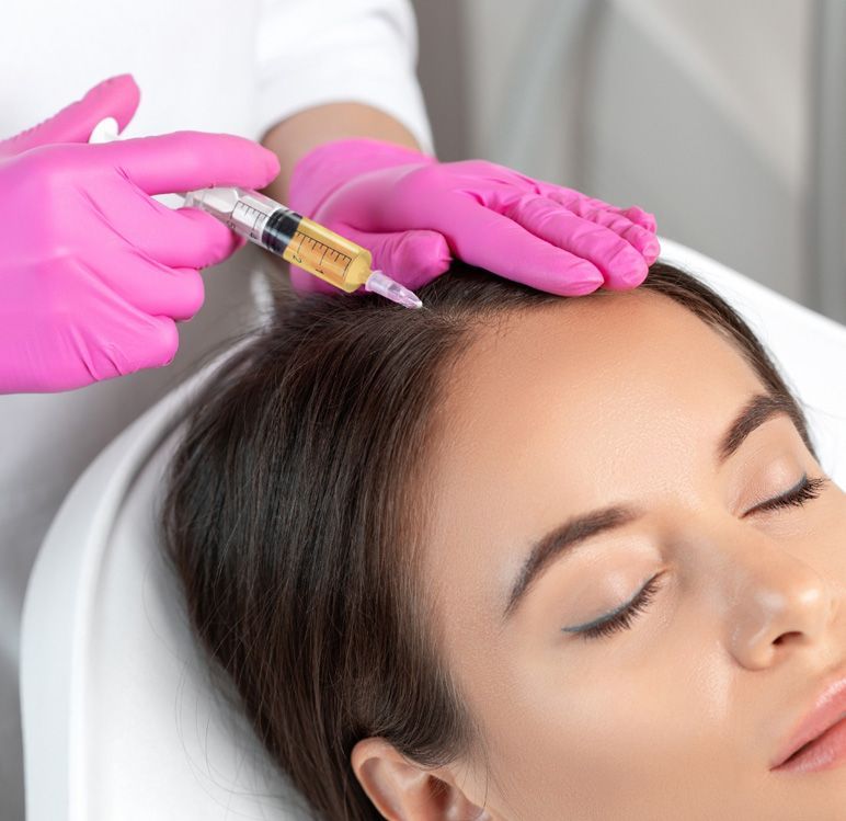 A woman is getting a botox injection in her head.