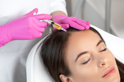 A woman is getting a botox injection in her head.