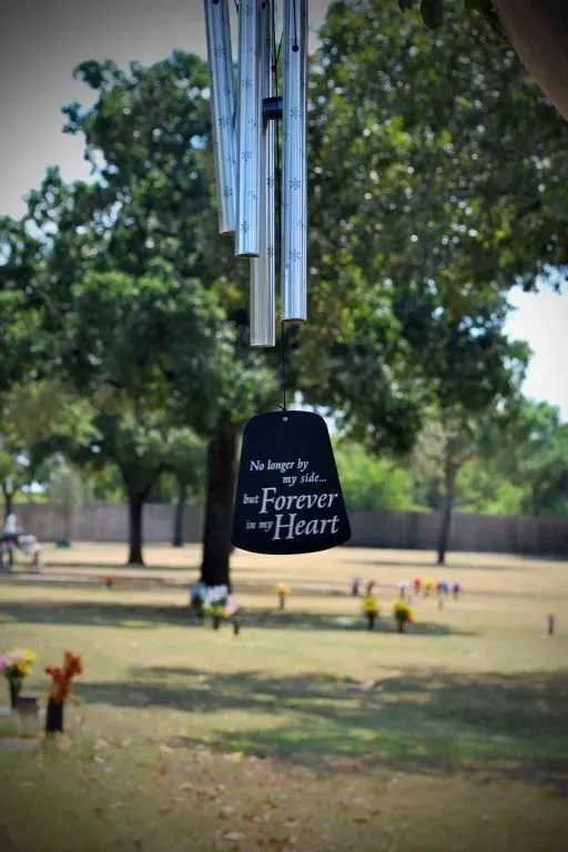 Wind chimes with a plaque reading 