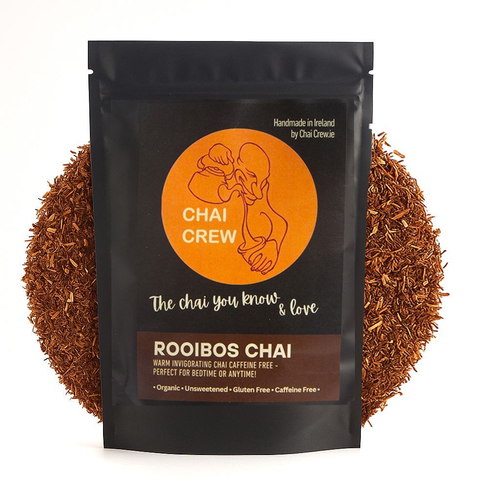 Black pouch of Rooibos Chai tea with a circle of tea around it.