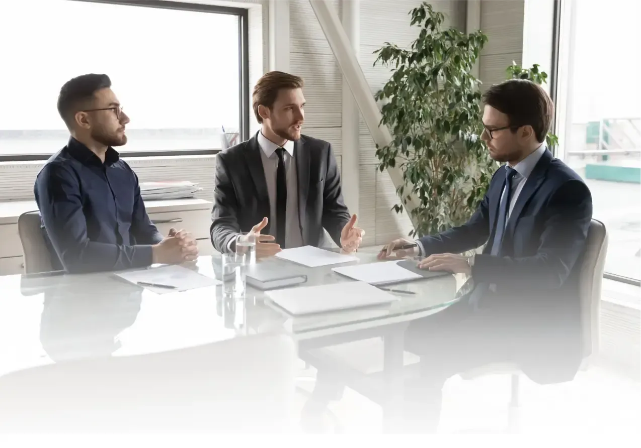 Three Men discussing something on a table